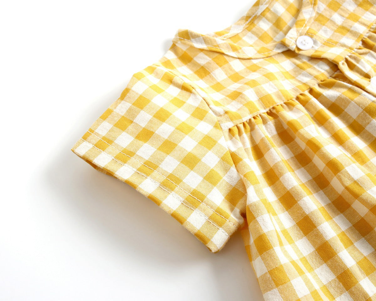 Yellow and white checkered dress on a white background