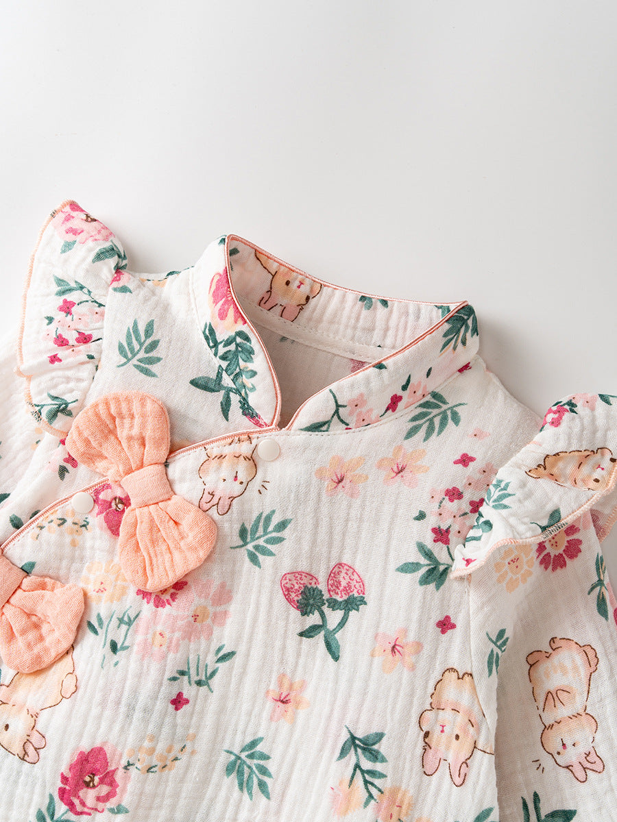 Floral and rabbit-patterned baby outfit with a bows on a white background