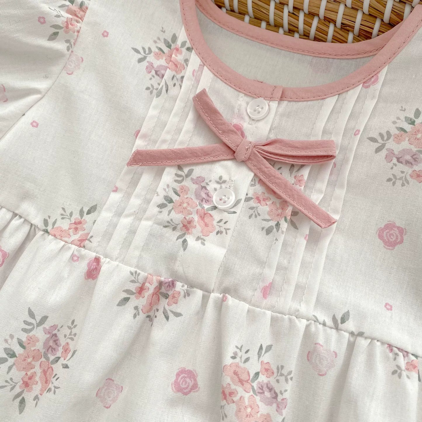 Floral dress with pink ribbon on a hanger