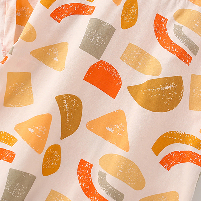 Patterned fabric with orange, yellow, and green shapes on a beige background