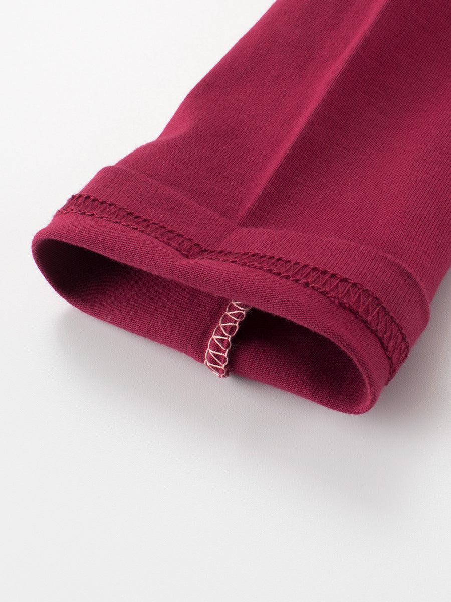 Close-up of a maroon fabric roll with visible stitching on a white background