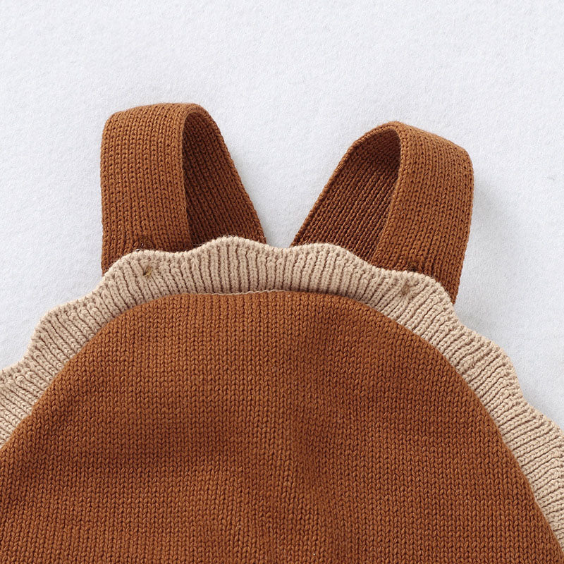 Brown knitted romper with beige trim on a light gray background