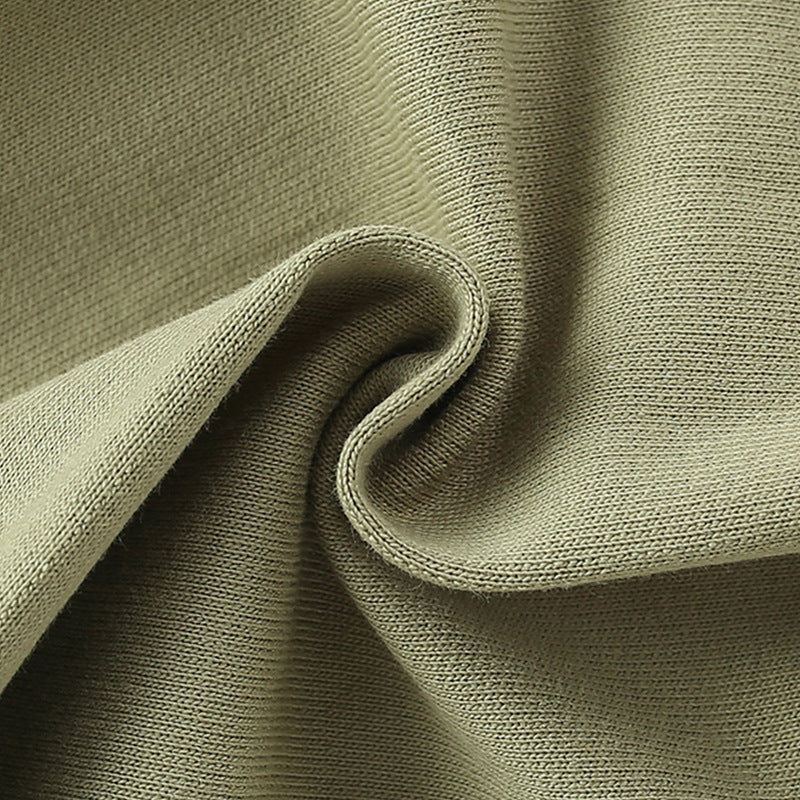 Close-up of textured green fabric with a slight sheen