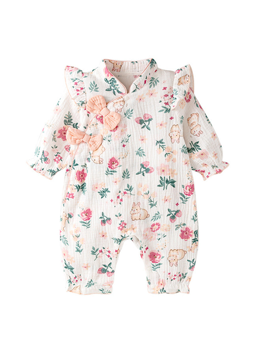 Floral baby romper with pink bows on a white background