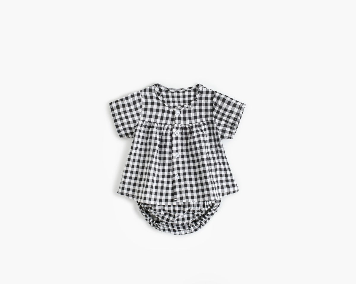 Black and white checkered baby romper on a white background