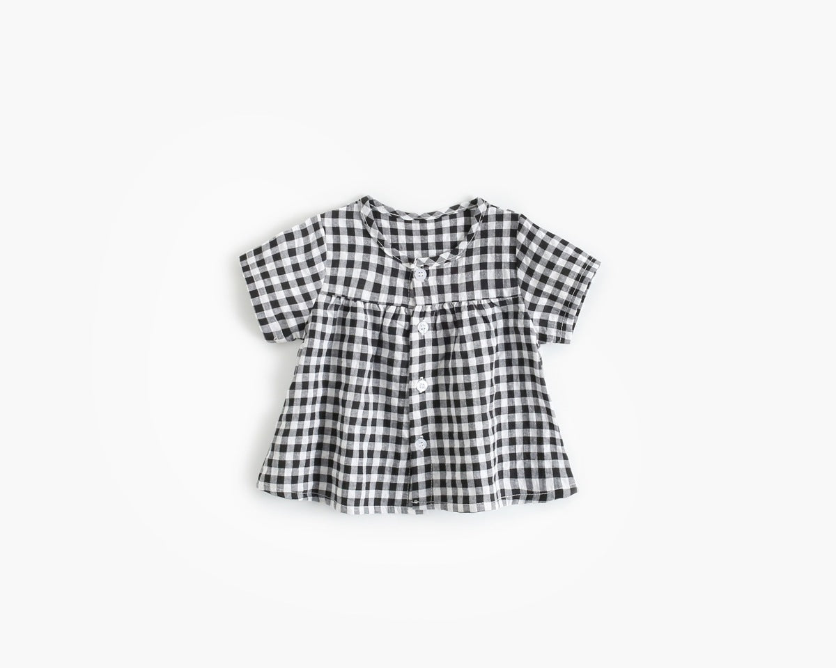 Black and white checkered blouse on a light beige background