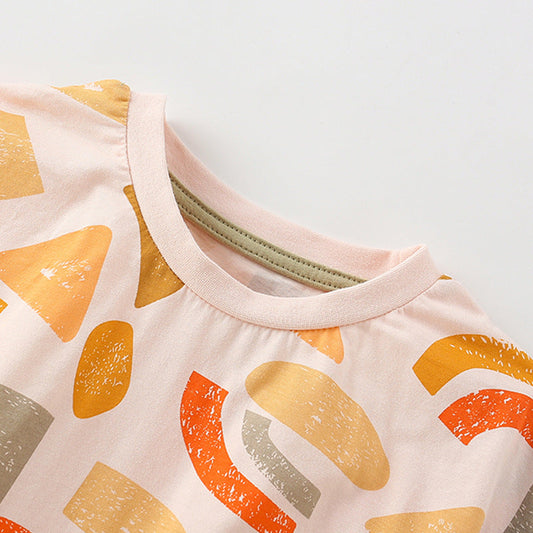 Close-up of a baby outfit with geometric pattern on a light background