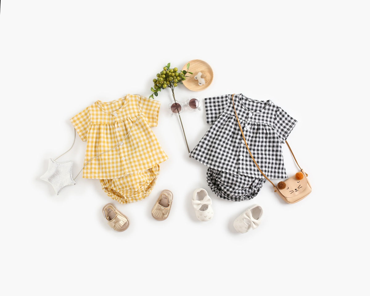 Yellow and black checkered baby outfits with shoes and a bag on a white background