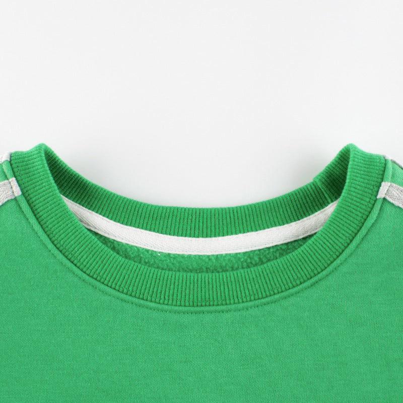 Close-up of a green sweater collar with white trim on a white background