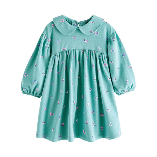 Green dress with butterfly pattern on a white background