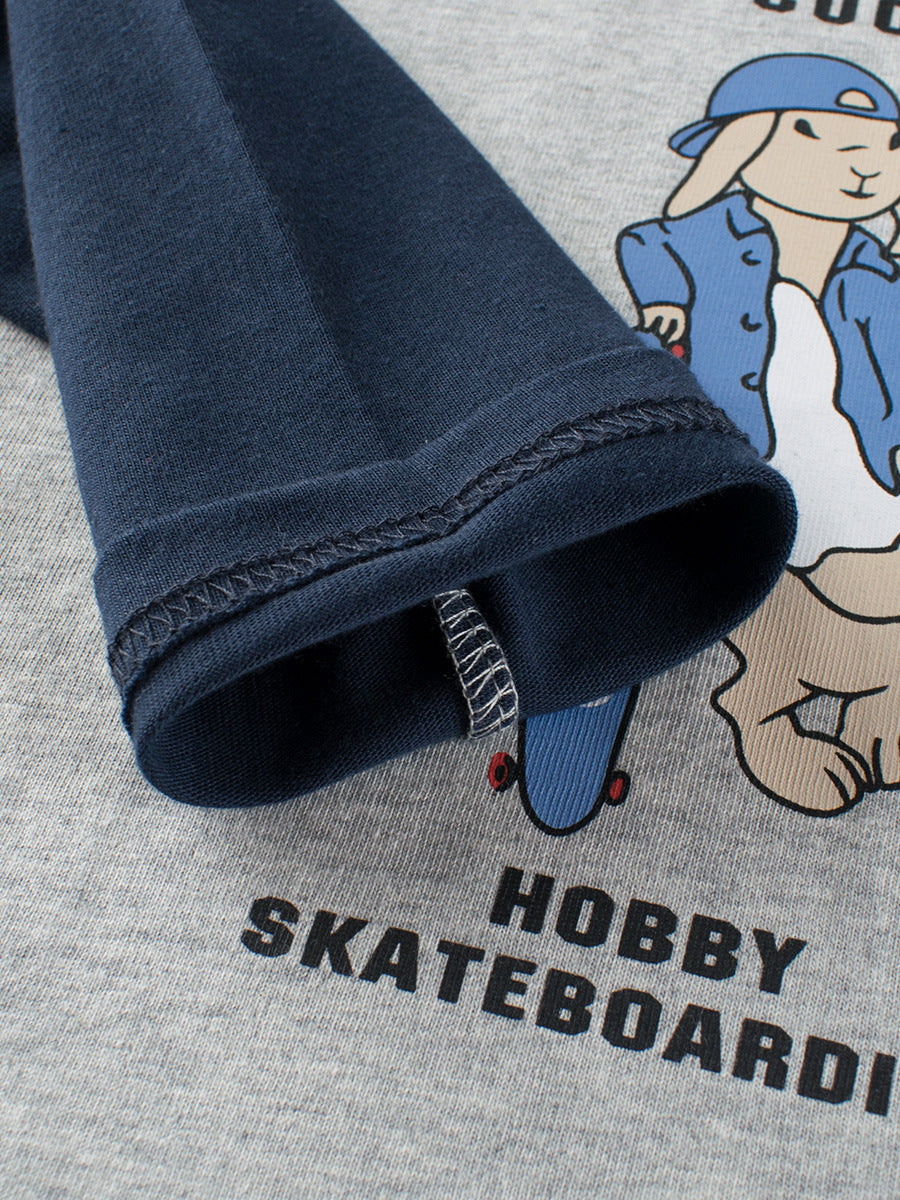 Gray sweatshirt with cartoon character and 'Hobby Skateboard' text, navy blue sleeve detail.