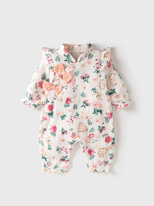 Floral baby romper with rabbits and flowers on a light gray background