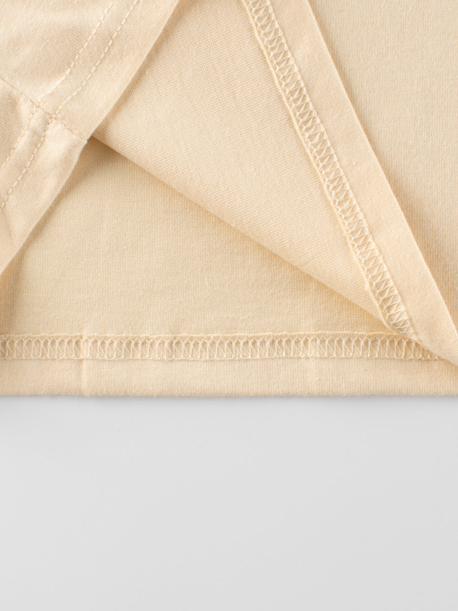 Close-up of beige fabric with a plain background